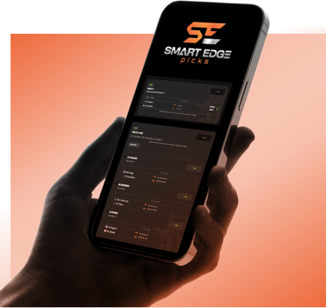 se-app-image A person pointing to their phone showing off their sports betting wins